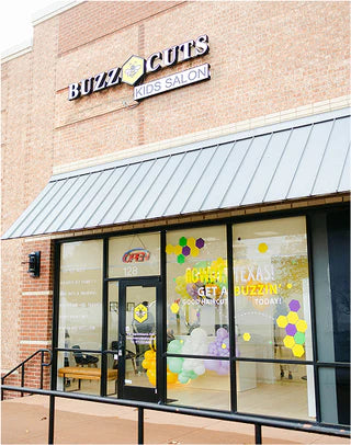 Buzz Kids Salon storefront with glass windows and visible interior.