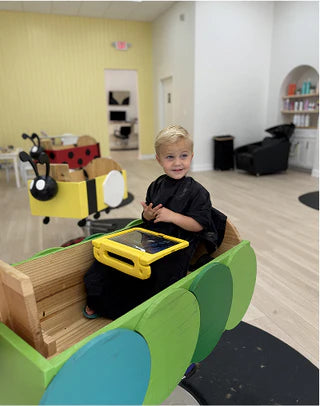 Child playing with a toy car in a room with colorful furniture