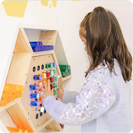 Child playing with a colorful wooden educational toy